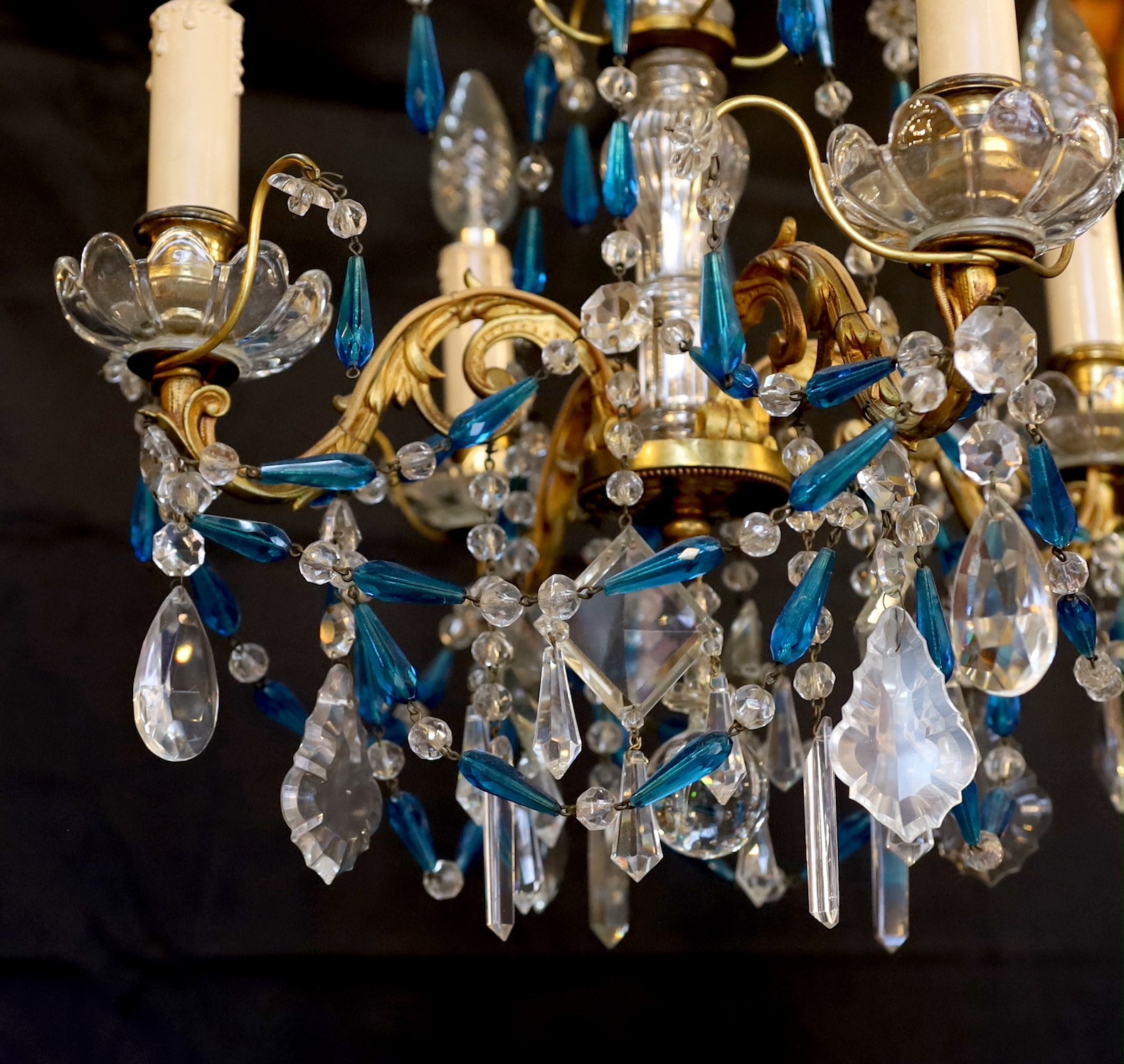 An early 20th century French gilt brass clear and blue glass four light chandelier, drop 80cm. width 40cm